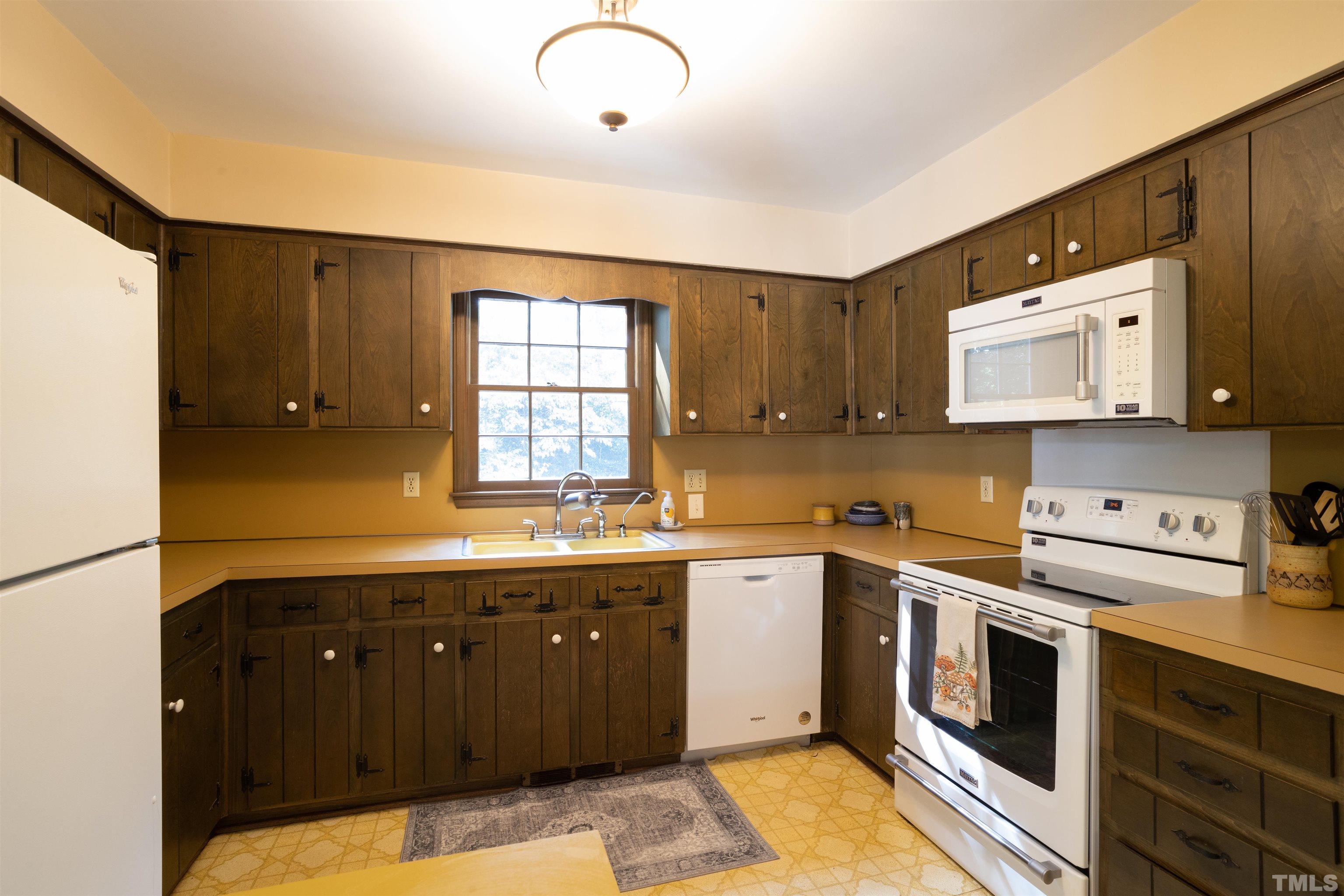 4324 Oak Park Road Raleigh, NC 27612 - Photo 11 of 33 a kitchen with a sink a stove and cabinets