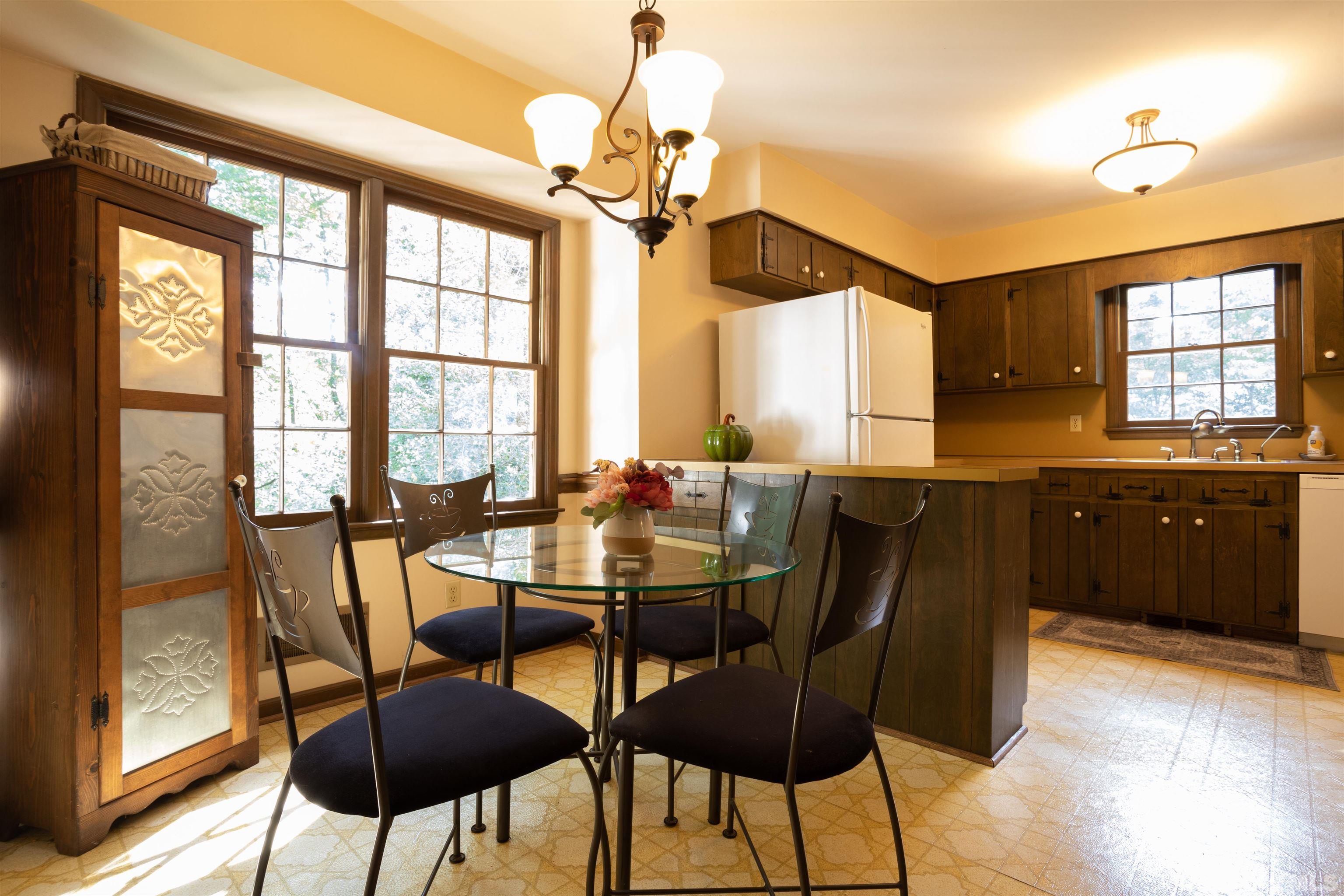 4324 Oak Park Road Raleigh, NC 27612 - Photo 13 of 33 a view of a dining room with furniture window and wooden floor