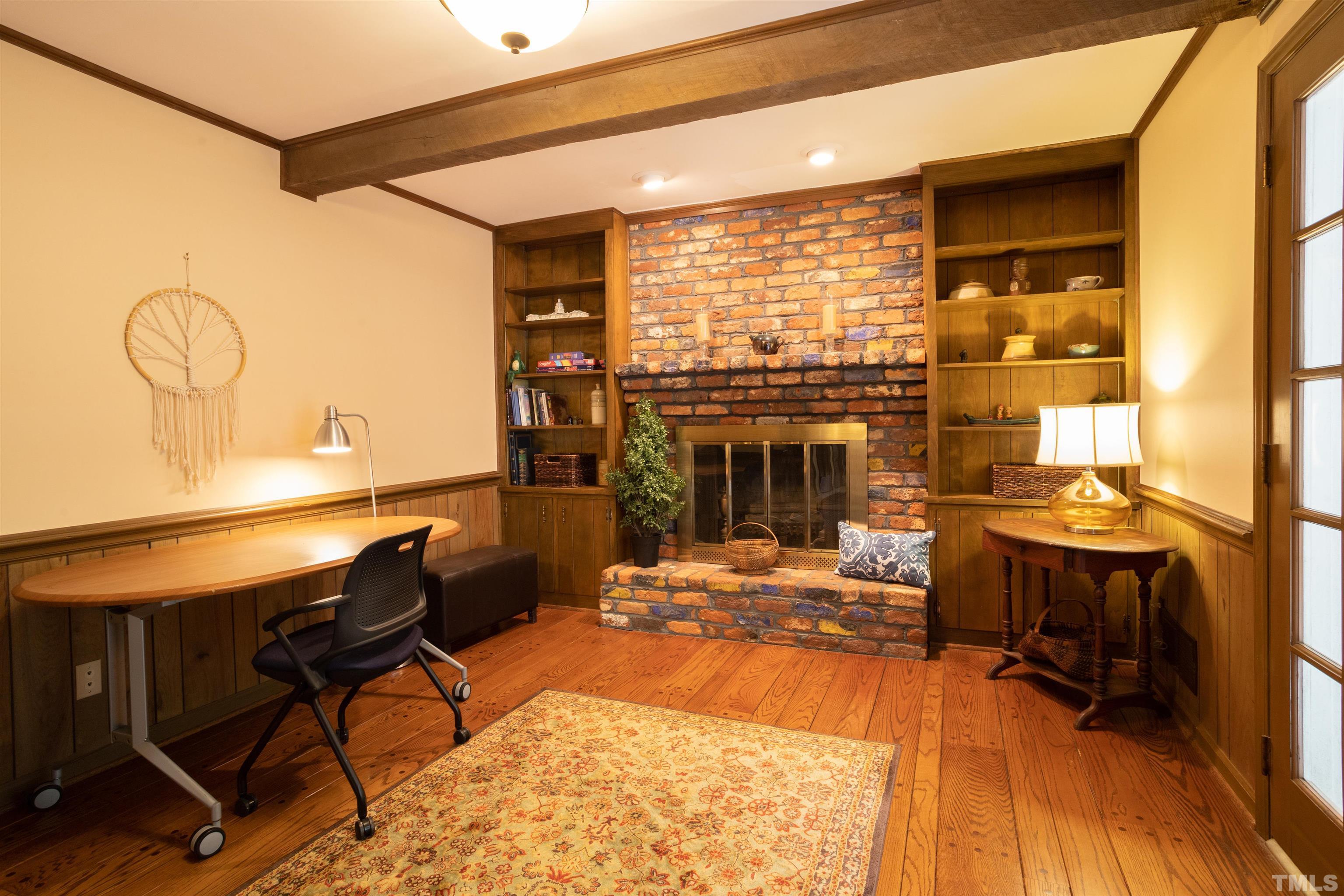 4324 Oak Park Road Raleigh, NC 27612 - Photo 16 of 33 a living room with fireplace furniture and a floor to ceiling window