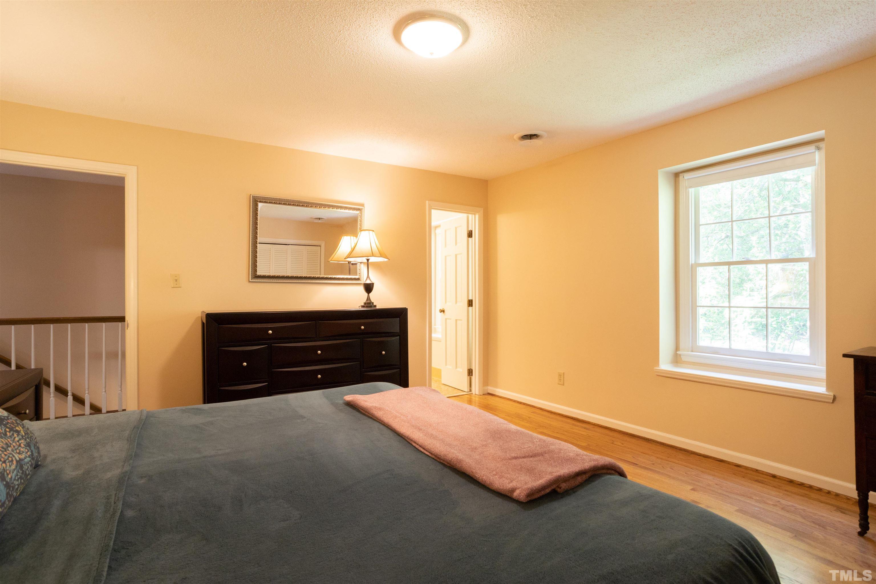 4324 Oak Park Road Raleigh, NC 27612 - Photo 20 of 33 a bedroom with a bed and a dresser