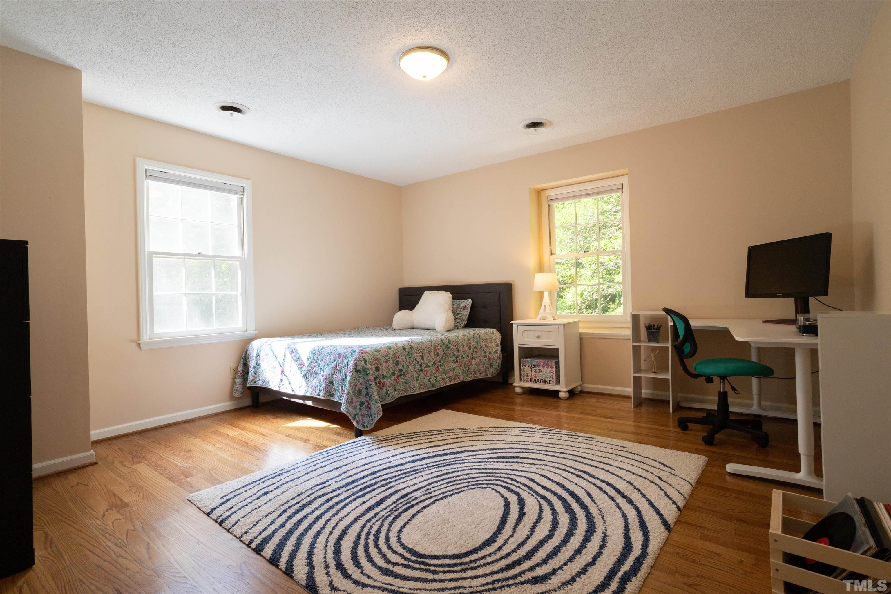 4324 Oak Park Road Raleigh, NC 27612 - Photo 23 of 33 a bedroom with a bed and a flat screen tv