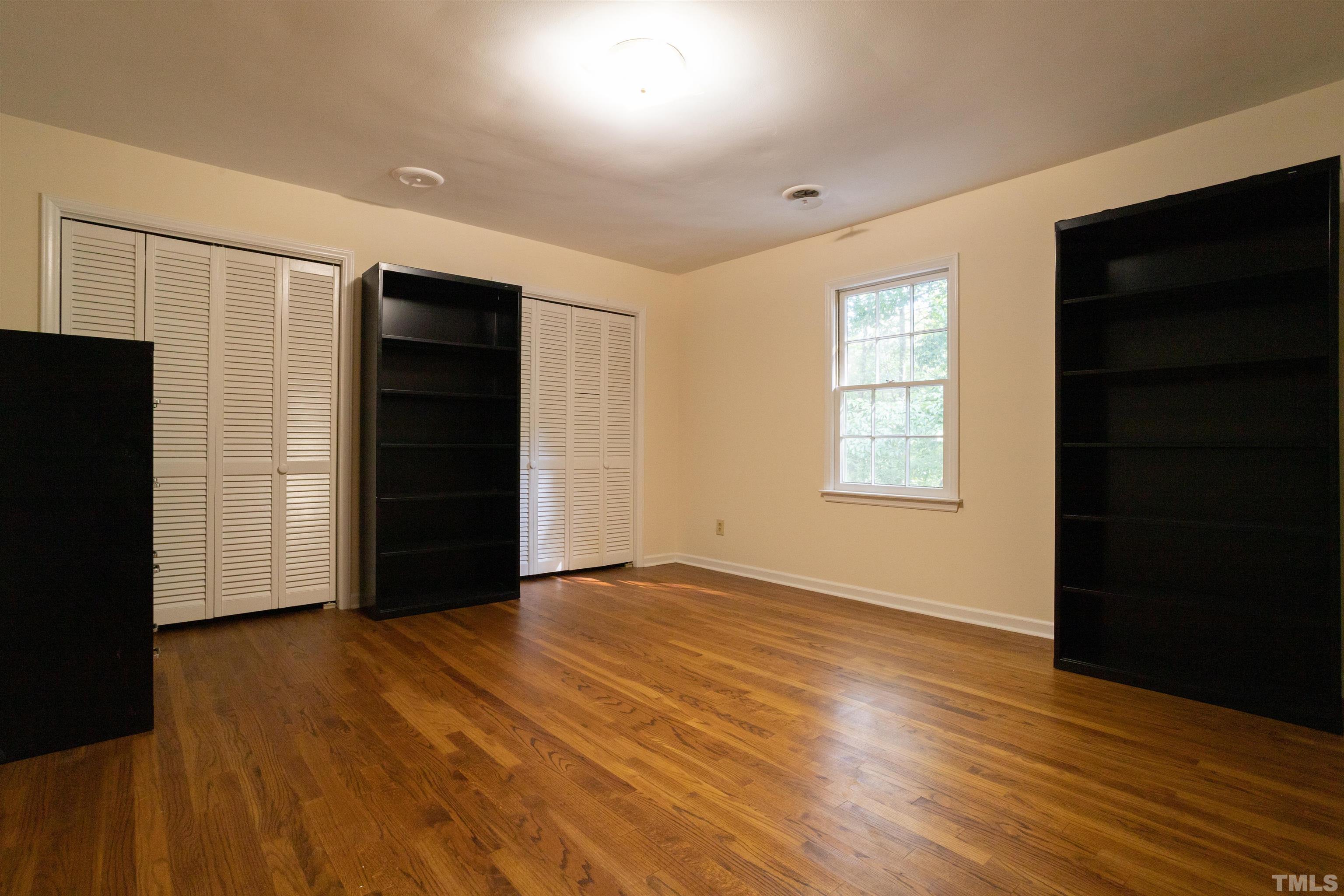 4324 Oak Park Road Raleigh, NC 27612 - Photo 25 of 33 an empty room with wooden floor and windows