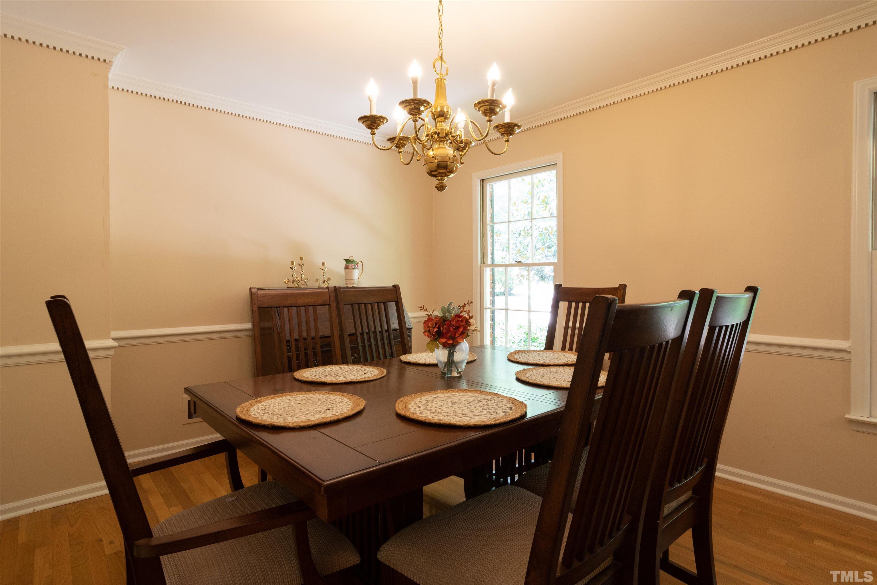 4324 Oak Park Road Raleigh, NC 27612 - Photo 8 of 33 a view of a dining room with furniture window and wooden floor