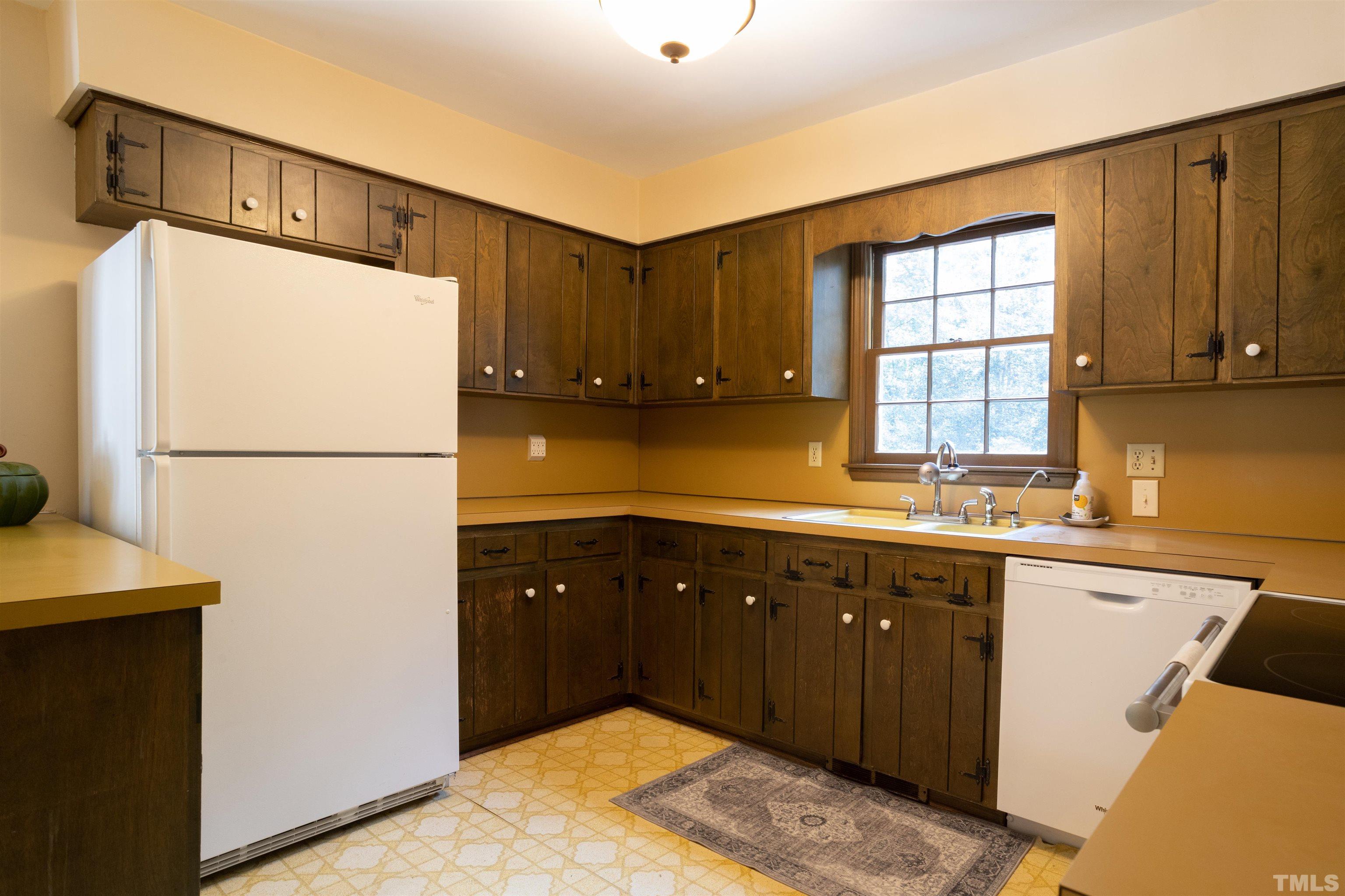4324 Oak Park Road Raleigh, NC 27612 - Photo 9 of 33 a kitchen with a refrigerator and a sink