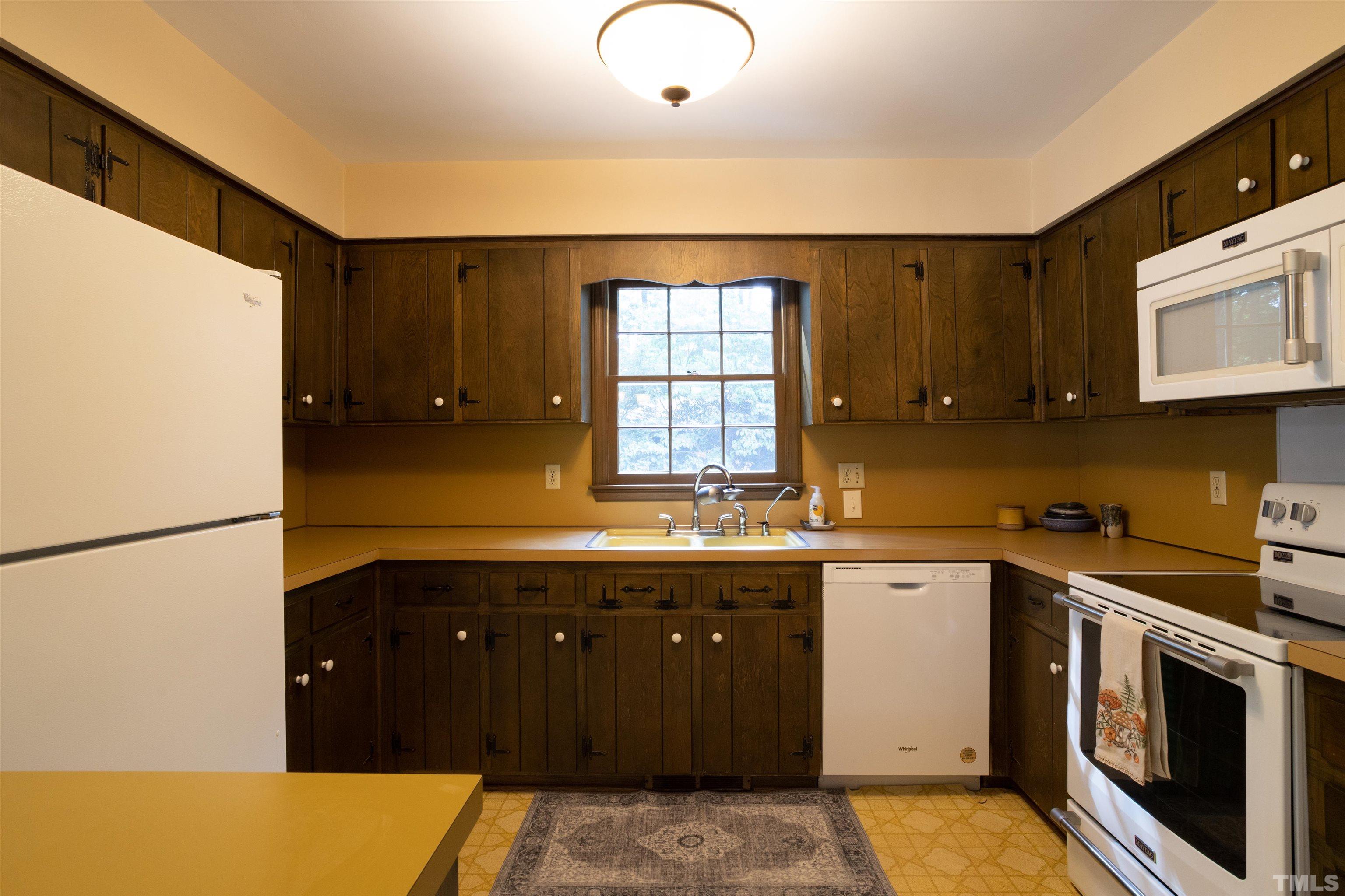 4324 Oak Park Road Raleigh, NC 27612 - Photo 10 of 33 a kitchen with a sink a stove and cabinets