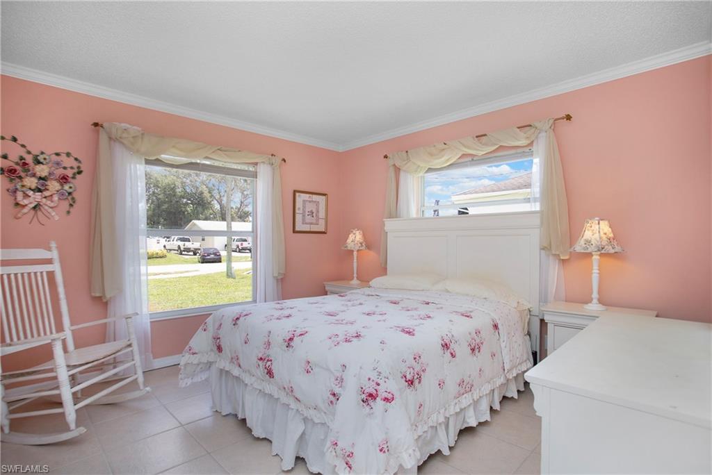 4736 25th Avenue Southwest Naples, FL 34116 - Photo 11 of 22 a bedroom with a bed and a window
