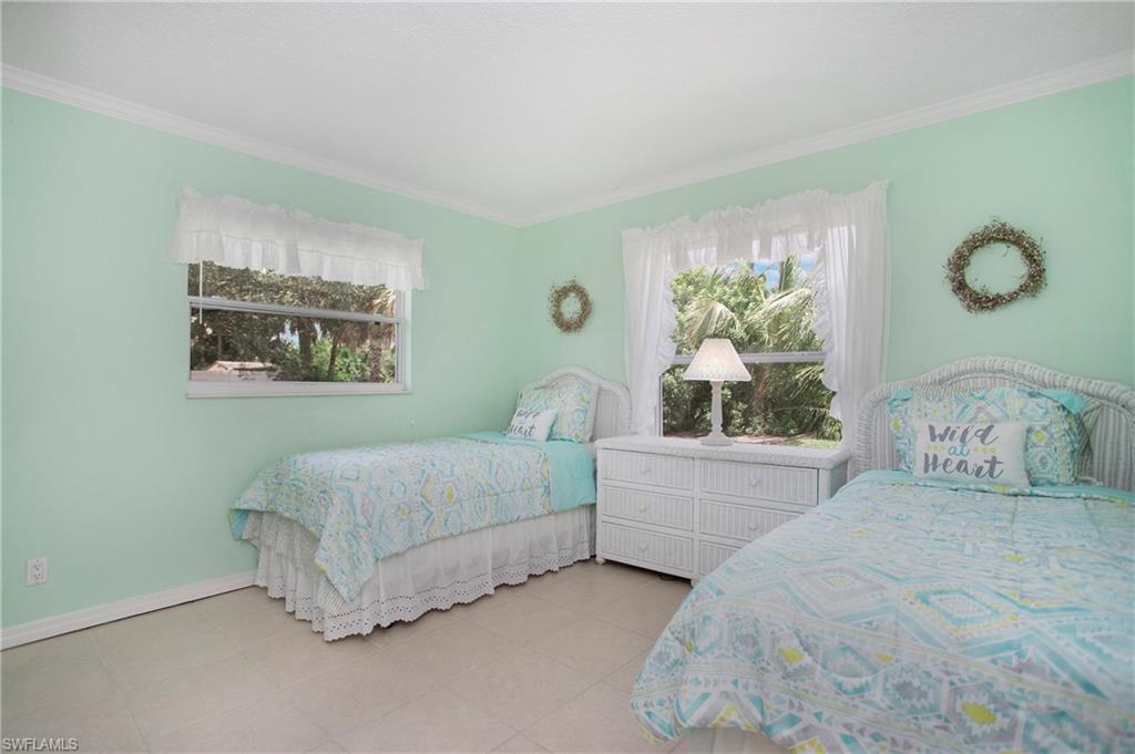 4736 25th Avenue Southwest Naples, FL 34116 - Photo 12 of 22 a bedroom with a bed and a window
