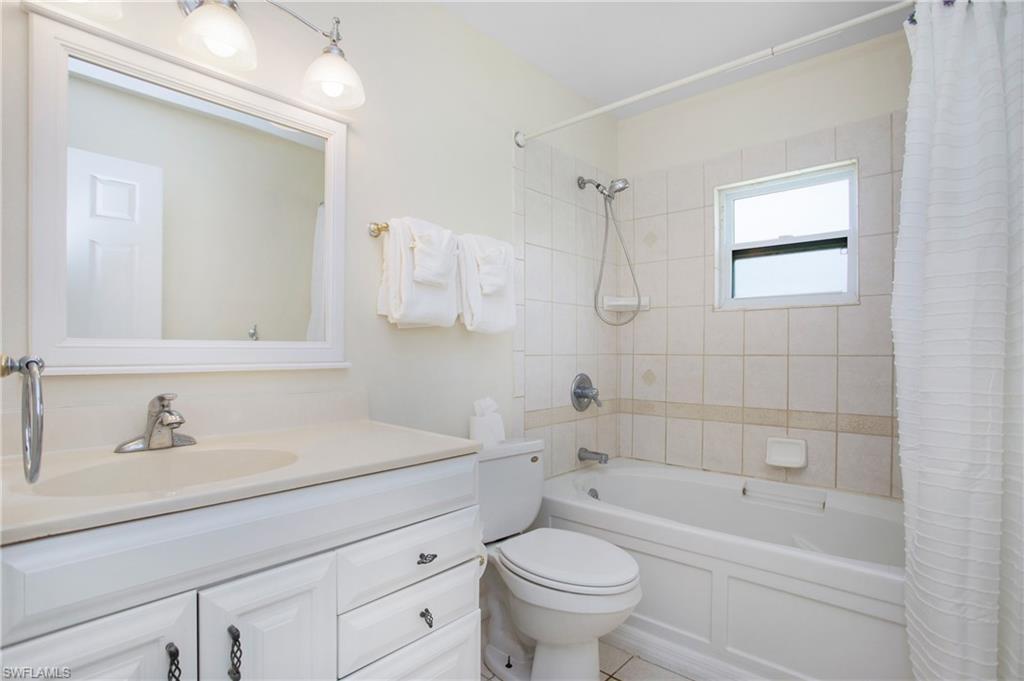 4736 25th Avenue Southwest Naples, FL 34116 - Photo 13 of 22 a bathroom with a sink a toilet and shower