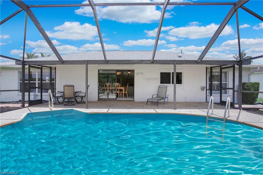 4736 25th Avenue Southwest Naples, FL 34116 - Photo 15 of 22 a view of a backyard with a patio and a garden