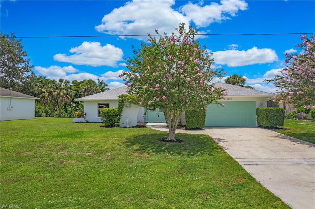 4736 25th Avenue Southwest Naples, FL 34116 - Photo 2 of 22 a front view of a house with garden