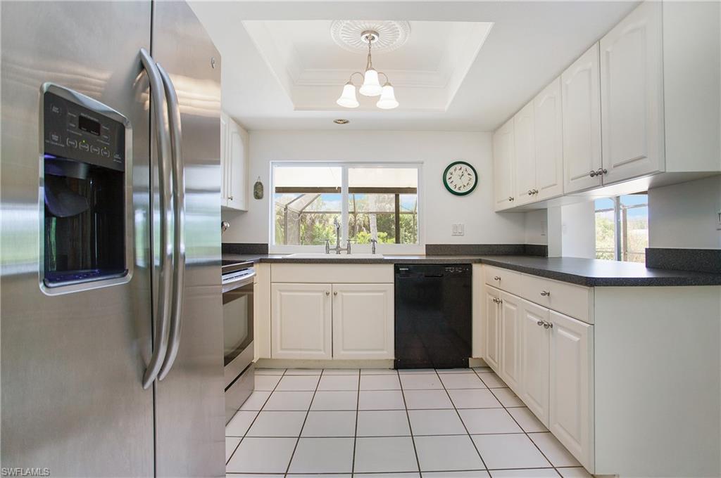 4736 25th Avenue Southwest Naples, FL 34116 - Photo 3 of 22 a kitchen with a sink a stove and cabinets