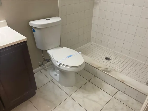 a bathroom with a toilet and a shower