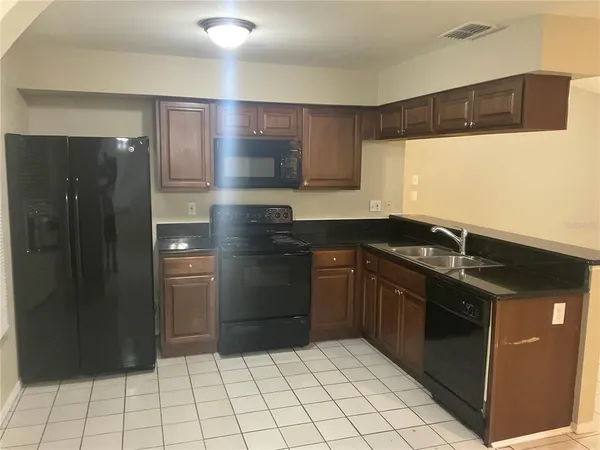 a kitchen with a sink cabinets and stainless steel appliances