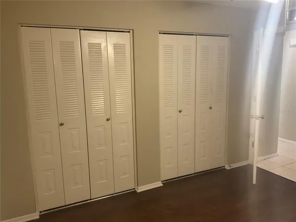 an empty room with closet area