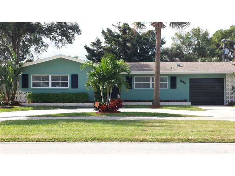 399 Southwest 12th Avenue Boca Raton, FL 33486 - Photo 1 of 19 a house that has a big yard and large trees