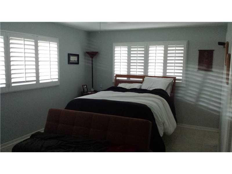 399 Southwest 12th Avenue Boca Raton, FL 33486 - Photo 11 of 19 a black and white photo of a bedroom