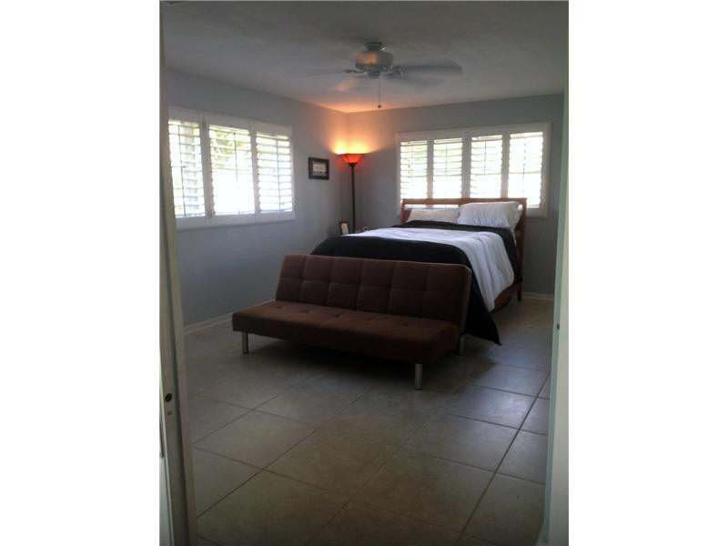 399 Southwest 12th Avenue Boca Raton, FL 33486 - Photo 12 of 19 a bedroom with a bed and window