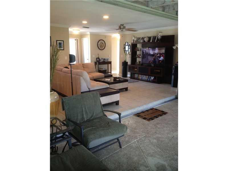 399 Southwest 12th Avenue Boca Raton, FL 33486 - Photo 15 of 19 a living room with furniture and a chandelier
