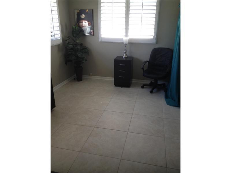 399 Southwest 12th Avenue Boca Raton, FL 33486 - Photo 18 of 19 a room with a desk and chair