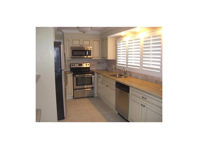 399 Southwest 12th Avenue Boca Raton, FL 33486 - Photo 3 of 19 a kitchen with stainless steel appliances a sink cabinets and a window