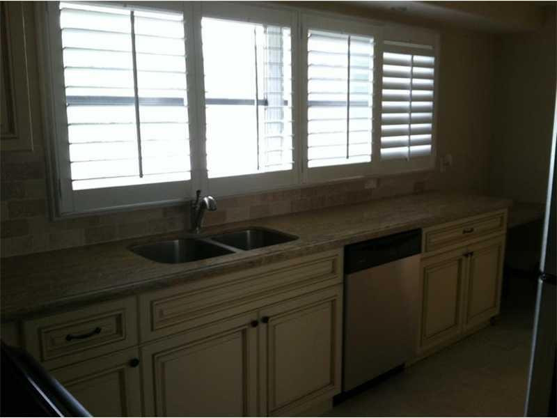 399 Southwest 12th Avenue Boca Raton, FL 33486 - Photo 4 of 19 a kitchen with a sink and large window