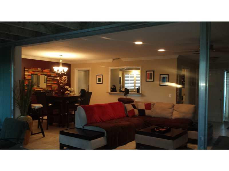399 Southwest 12th Avenue Boca Raton, FL 33486 - Photo 5 of 19 a living room with furniture and a mirror