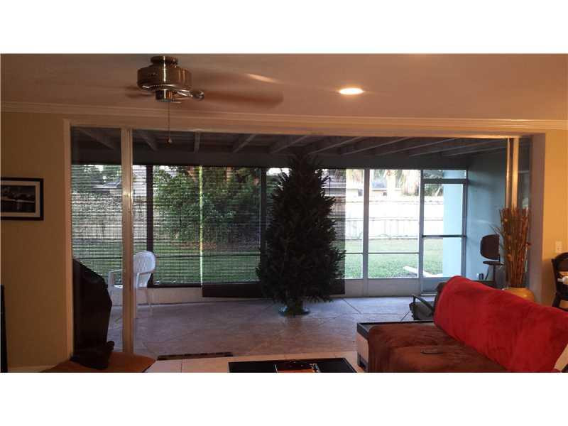 399 Southwest 12th Avenue Boca Raton, FL 33486 - Photo 6 of 19 a living room with furniture and a floor to ceiling window