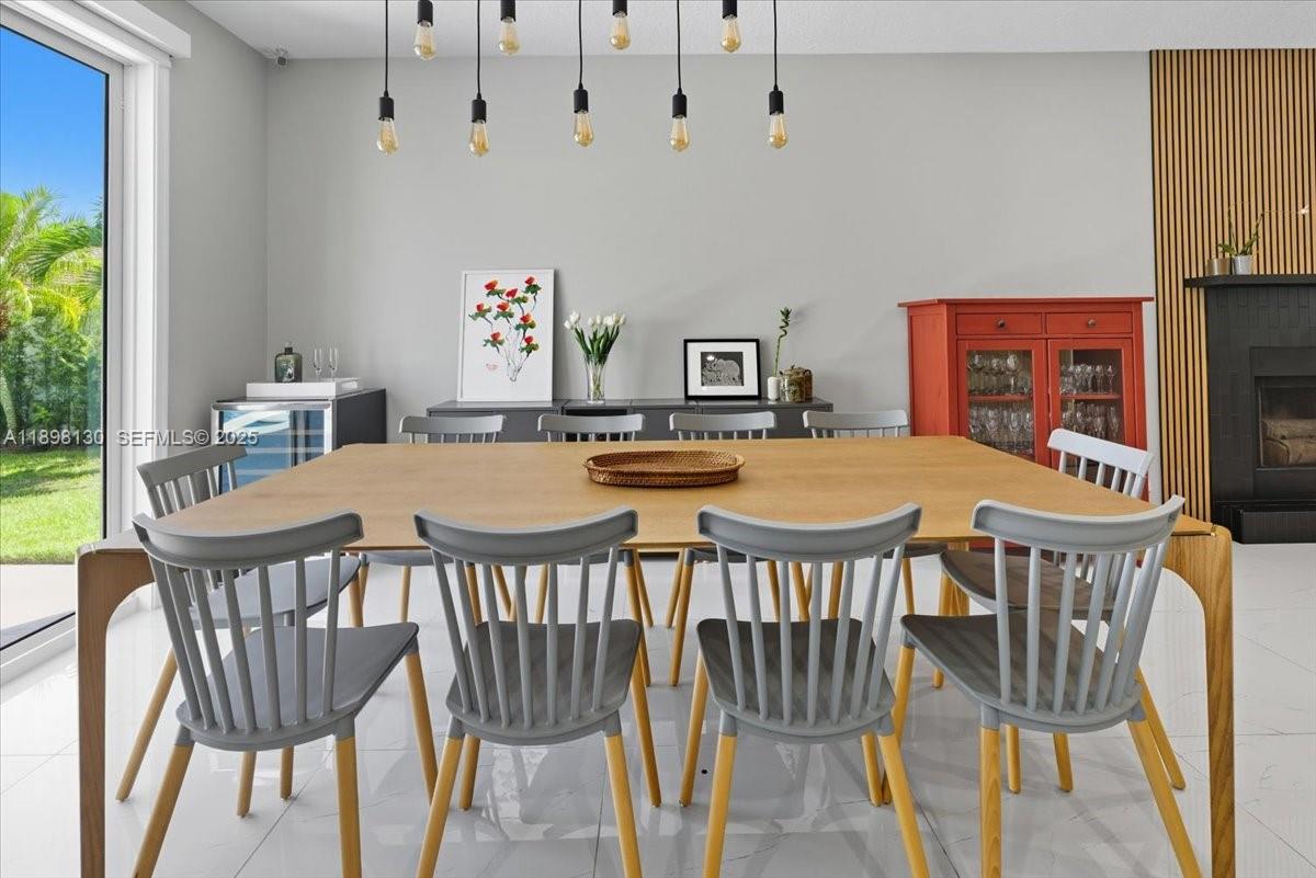 347 Fairmont Road Weston, FL 33326 - Photo 15 of 42 a view of a dining room with furniture and wooden floor