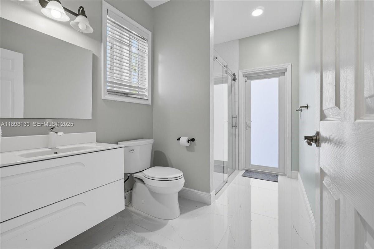 347 Fairmont Road Weston, FL 33326 - Photo 18 of 42 a bathroom with a sink toilet a shower and a mirror