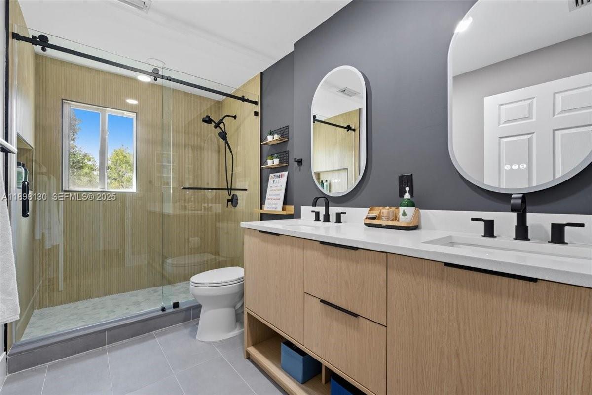 347 Fairmont Road Weston, FL 33326 - Photo 29 of 42 a bathroom with a double vanity sink mirror and toilet