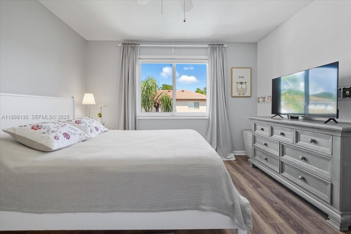 347 Fairmont Road Weston, FL 33326 - Photo 31 of 42 a bedroom with a bed and a flat screen tv