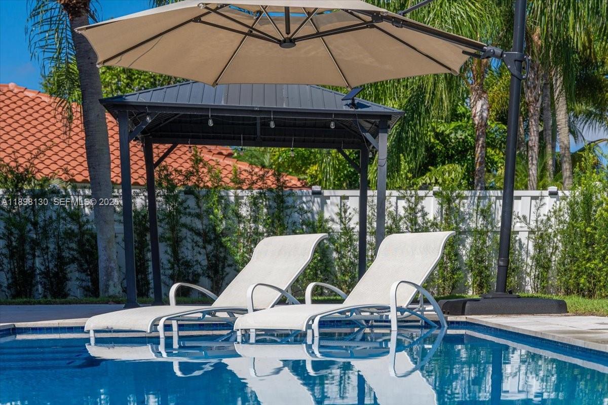 347 Fairmont Road Weston, FL 33326 - Photo 33 of 42 a view of backyard of house with seating space