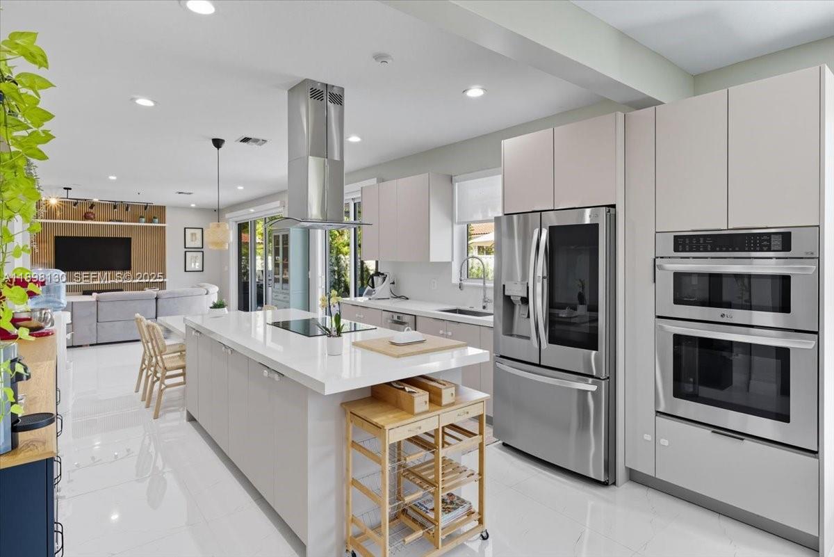 347 Fairmont Road Weston, FL 33326 - Photo 5 of 42 a kitchen with stainless steel appliances a stove a sink and a refrigerator