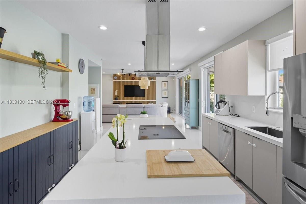 347 Fairmont Road Weston, FL 33326 - Photo 7 of 42 a kitchen with stainless steel appliances kitchen island granite countertop a sink and a stove