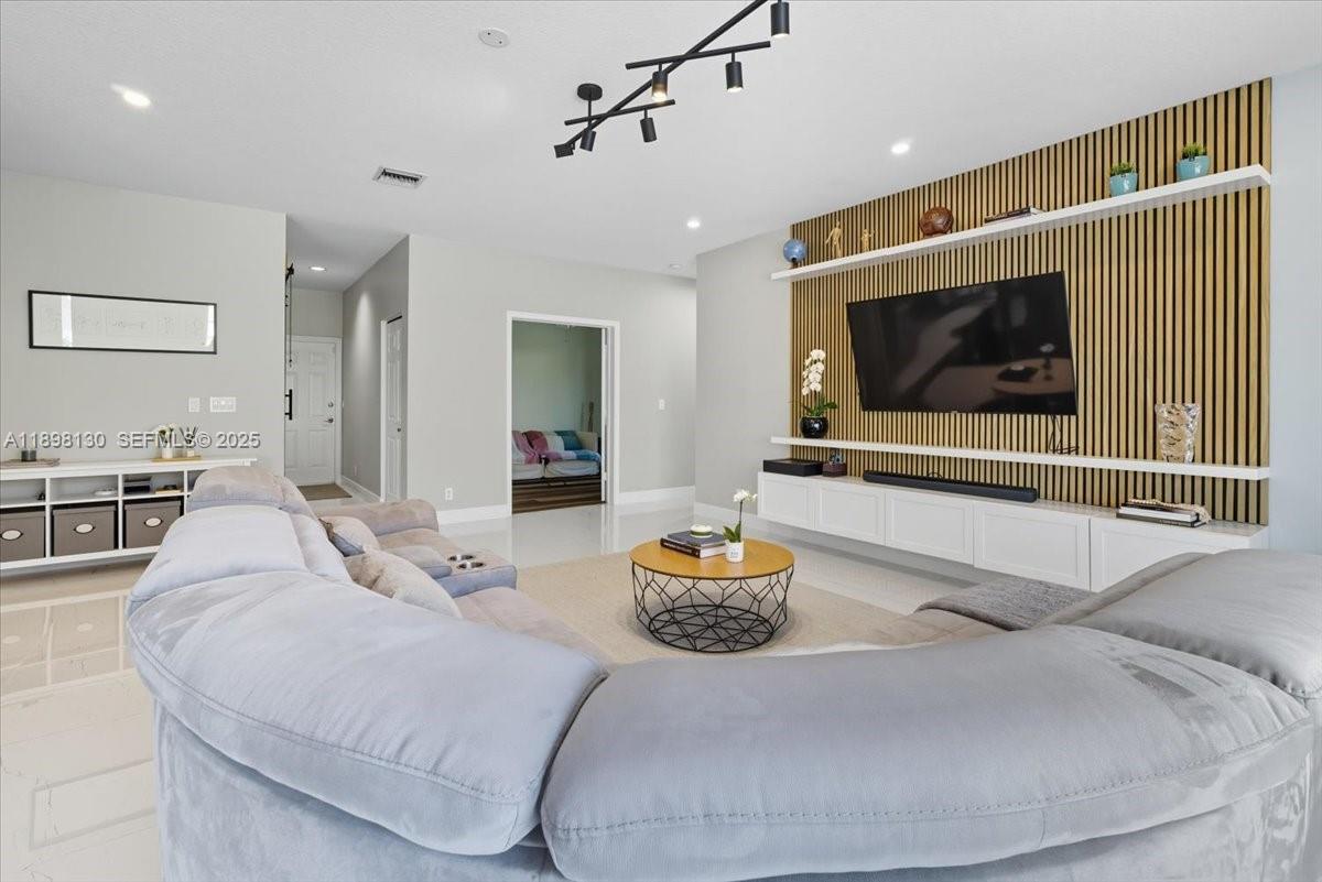 347 Fairmont Road Weston, FL 33326 - Photo 8 of 42 a living room with furniture and a flat screen tv