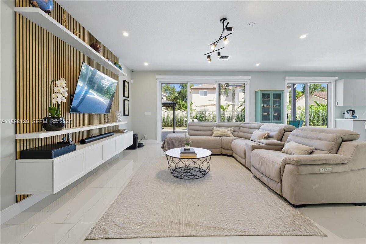 347 Fairmont Road Weston, FL 33326 - Photo 9 of 42 a living room with furniture and a flat screen tv