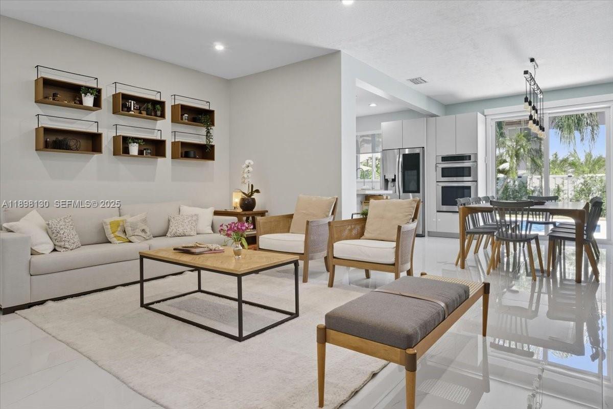 347 Fairmont Road Weston, FL 33326 - Photo 10 of 42 a living room with furniture a rug kitchen view and a window