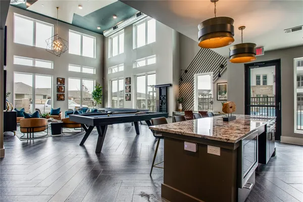 a dining hall with couches and wooden floor