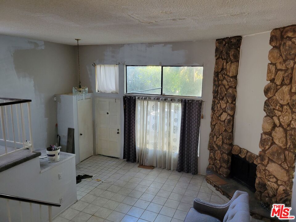 20224 Sherman Way, Unit 27 Canoga Park, CA 91306 - Photo 4 of 13 an empty room with windows and closet