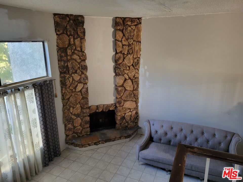 20224 Sherman Way, Unit 27 Canoga Park, CA 91306 - Photo 5 of 13 a living room with furniture and a fireplace