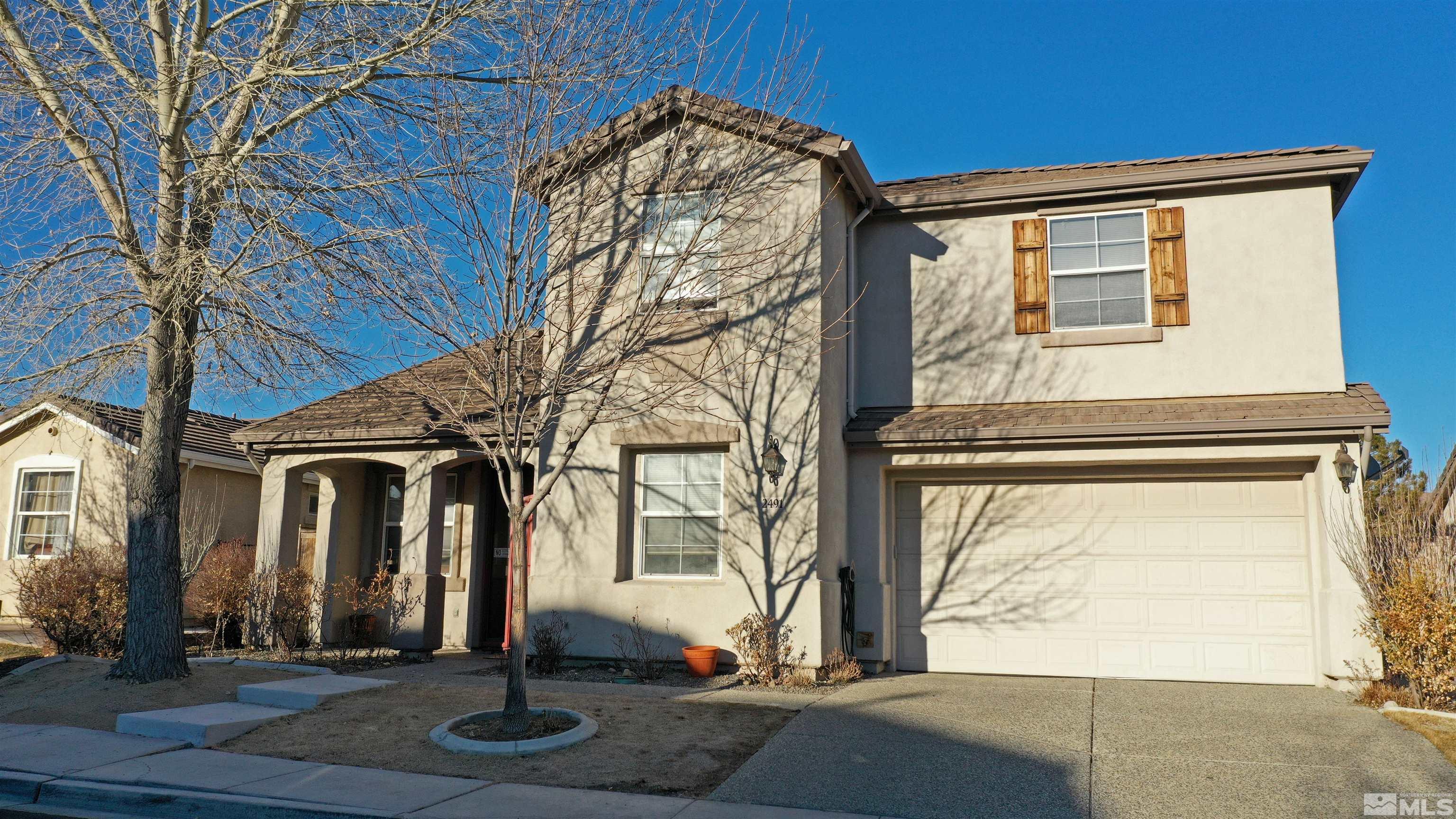 2491 Spring Flower Drive Reno, NV 89521 - Photo 1 of 19 a front view of a house with a yard