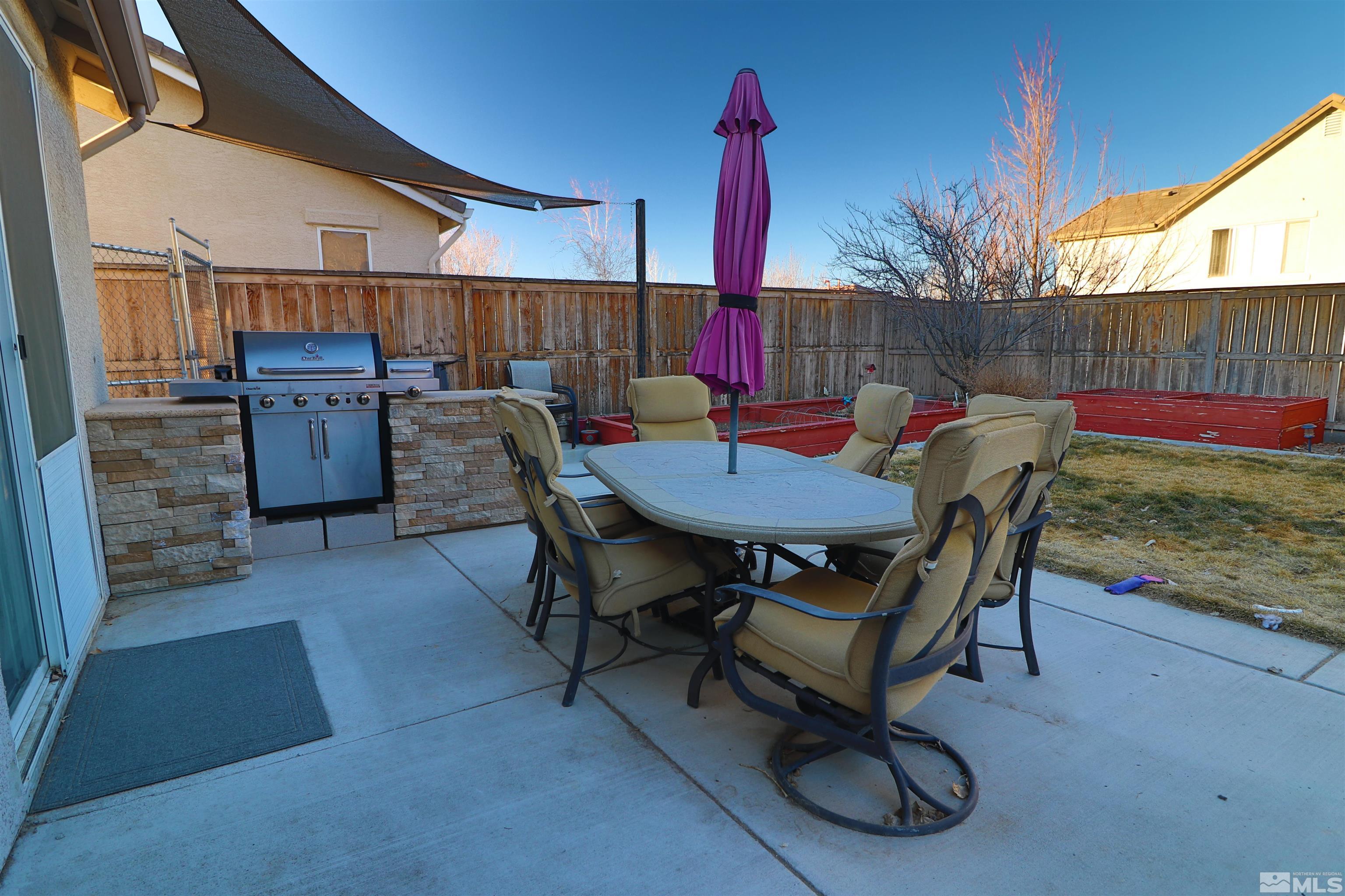 2491 Spring Flower Drive Reno, NV 89521 - Photo 17 of 19 a view of a patio with a table and chairs
