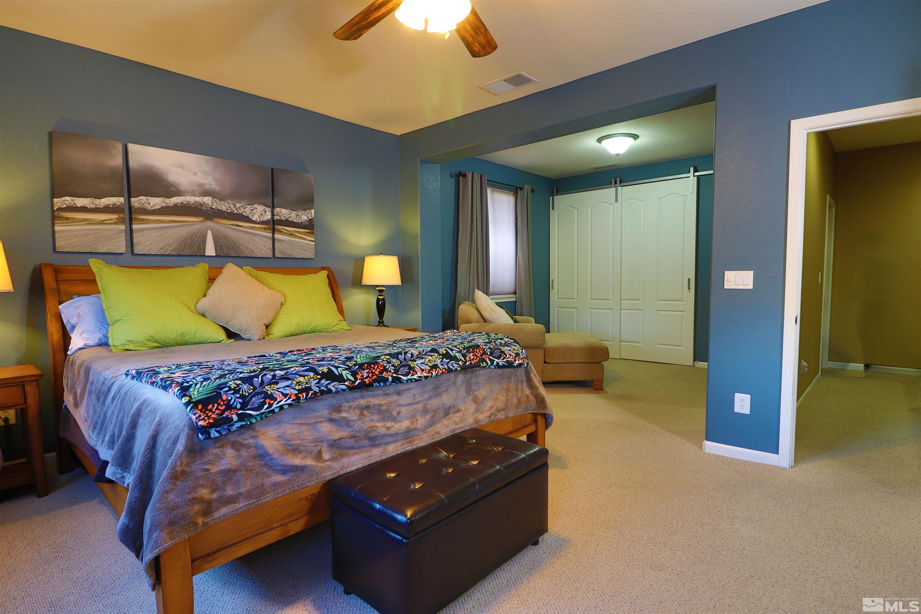 2491 Spring Flower Drive Reno, NV 89521 - Photo 10 of 19 a bedroom with a bed and a chandelier