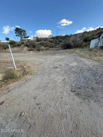 a view of a dry yard with a barn