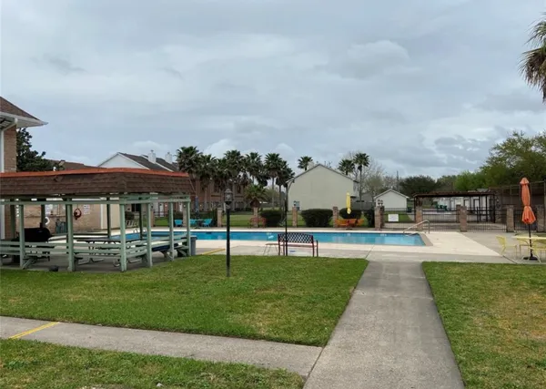 a view of a swimming pool and lounge chairs in the park