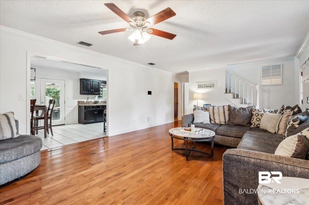 3616 Vista Ridge Drive Mobile, AL 36693 - Photo 4 of 20 Living room featuring a textured ceiling, tile patterned floors, crown molding, and ceiling fan