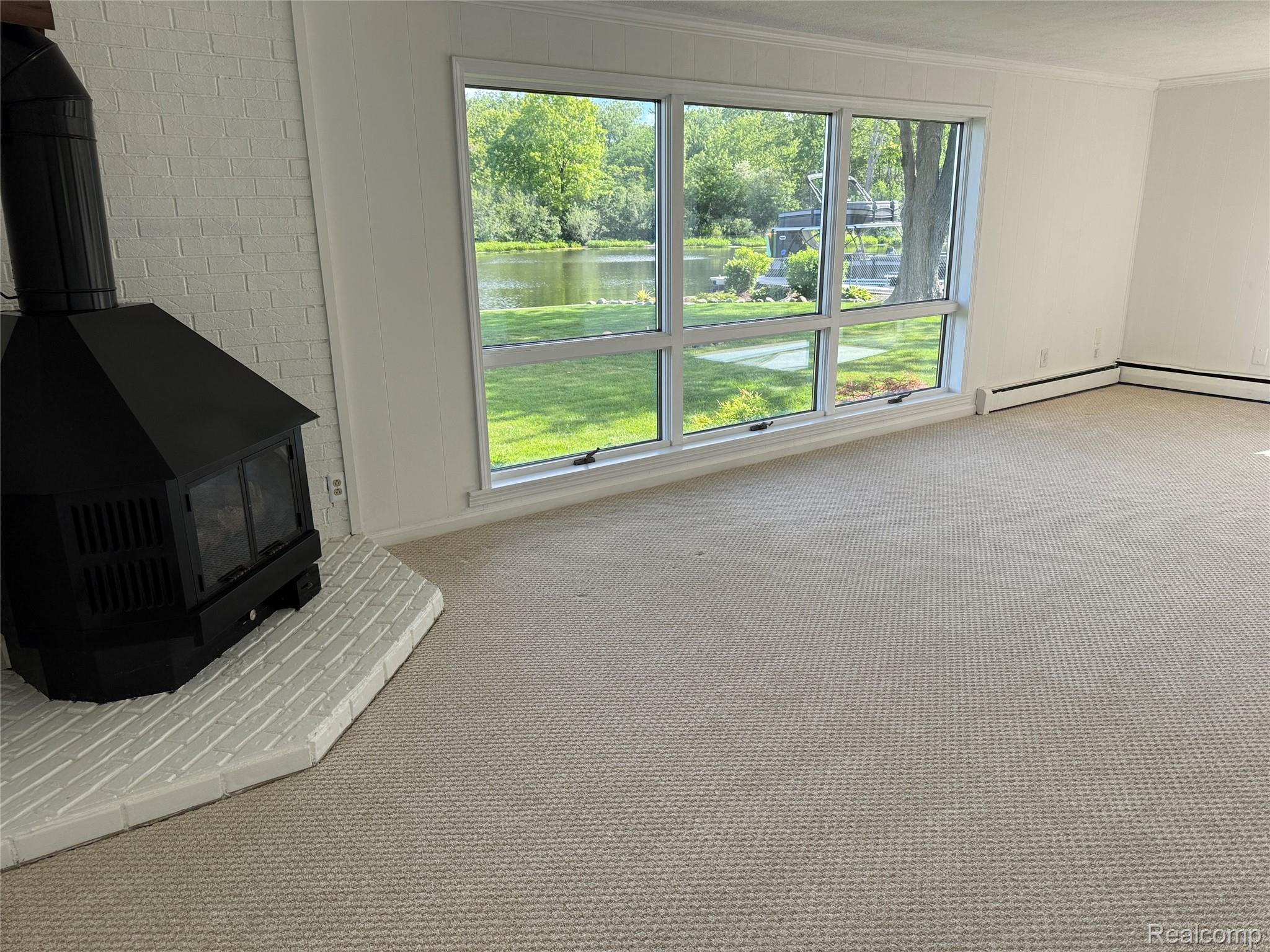 3138 Ponemah Drive Fenton, MI 48430 - Photo 13 of 19 Bright interior space with large picture windows offering a water feature and green landscape