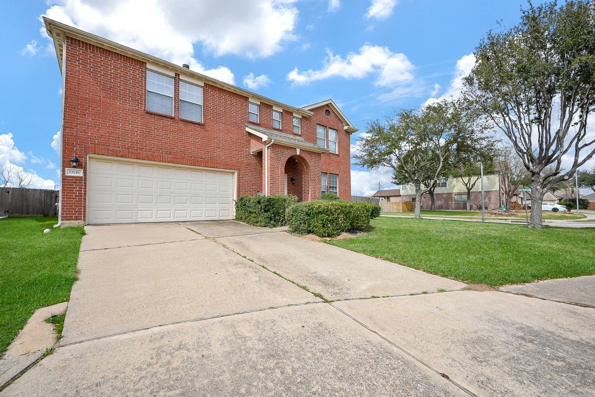 6638 Autumn Sunset Lane Spring, TX 77379 - Photo 2 of 32 Charming brick facade with a spacious driveway and well-maintained landscaping, offering excellent curb appeal.