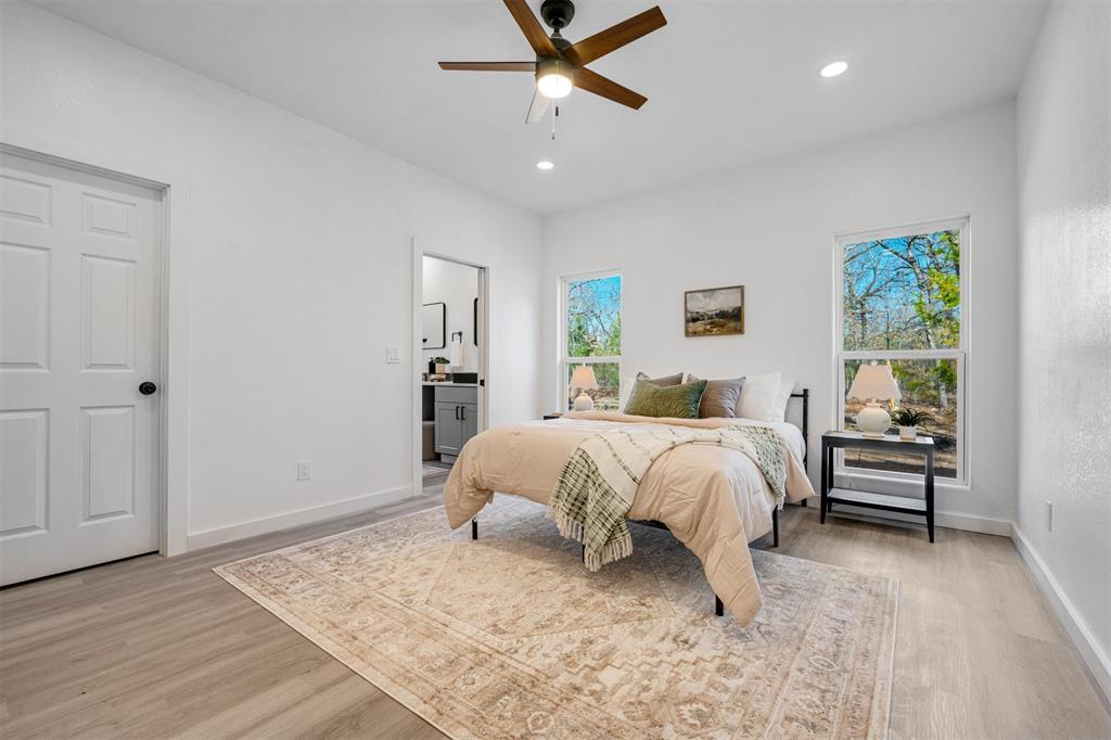 260 Private Road Sumner, TX 75486 - Photo 12 of 23 a bed sitting in a spacious bedroom next to a window