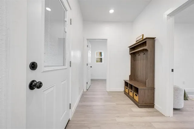 a view of a hallway with wooden floor